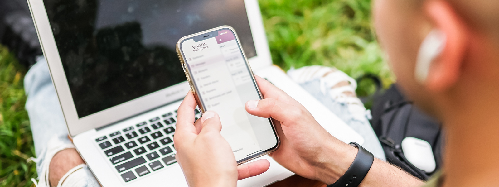 A man checks his bank account on his phone.