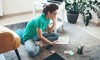 Young woman going over finances in living room