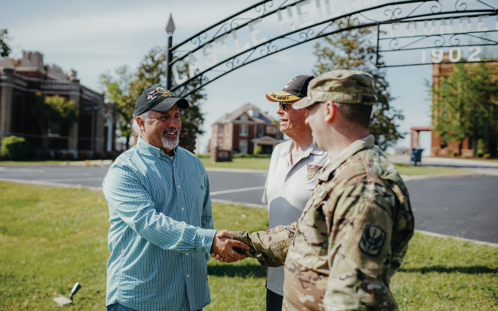 A man shaking another man's hand that is in his Army uniform.