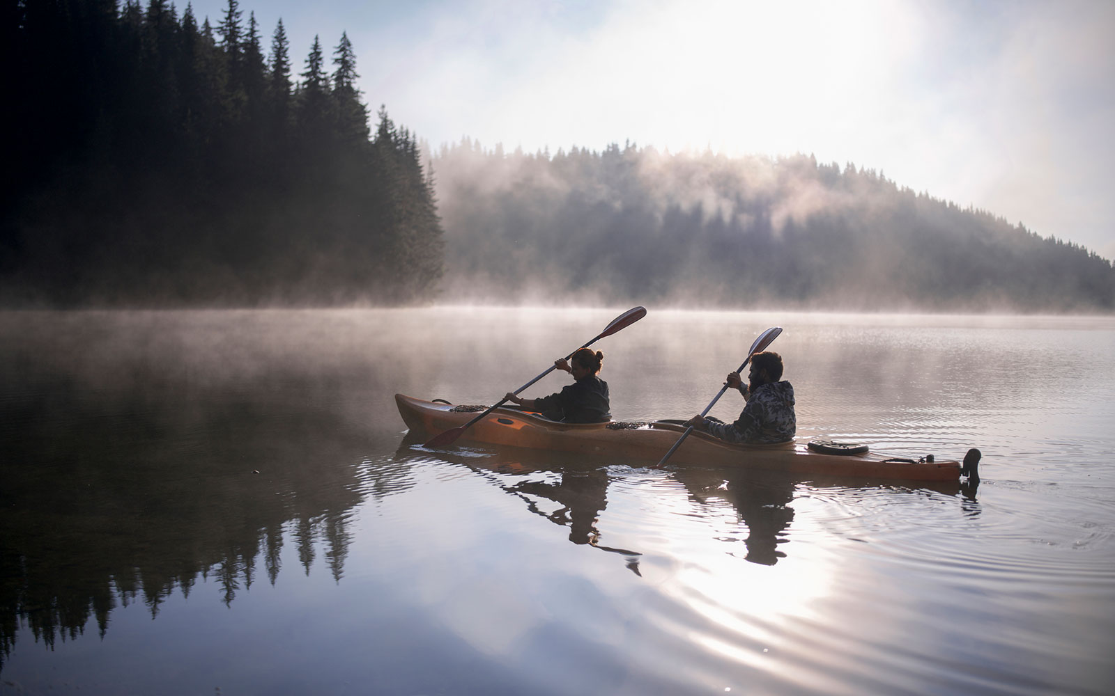 Two people rowing in a canoe.