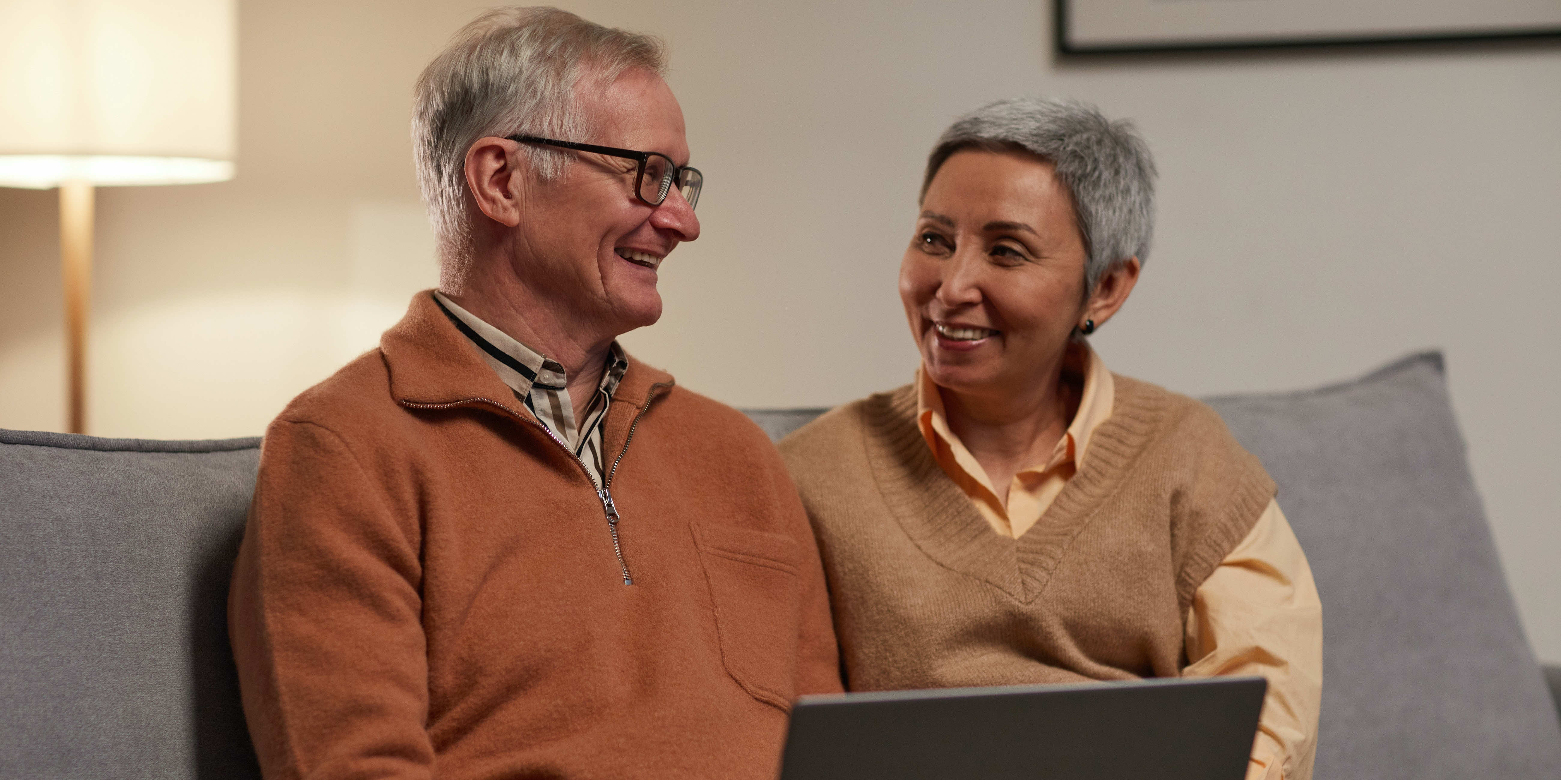 elderly couple working on their computer