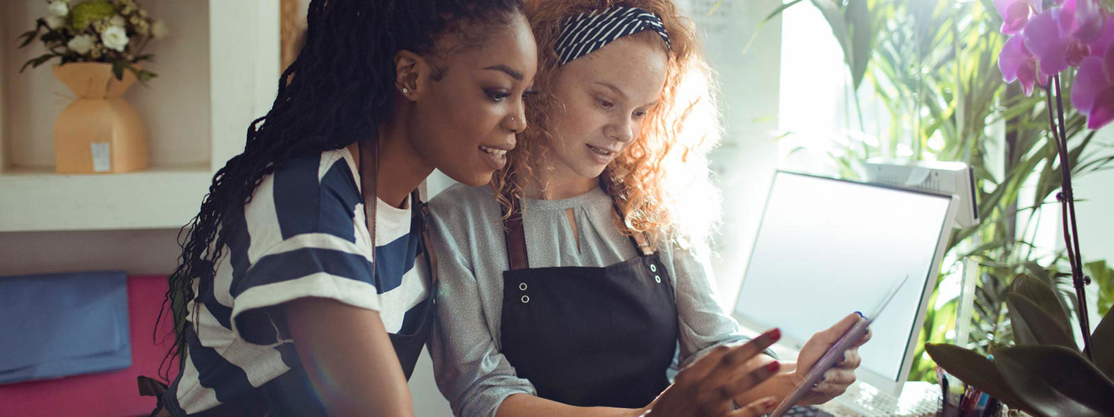 Two business woman using tablet