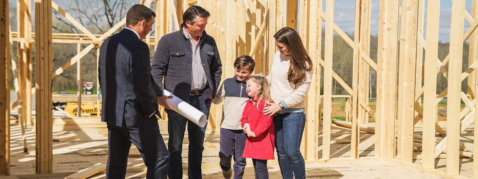 A family looking at there new home that is being built