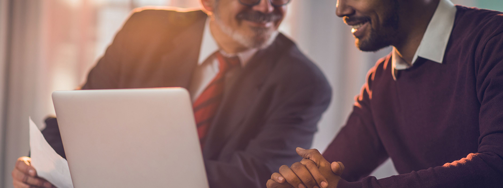 Business men discuss a deal over a computer