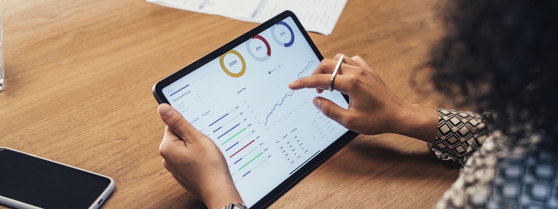 Woman is going over financials for her business on her tablet