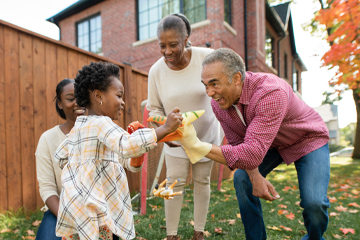 A family laughing together in the backyard.