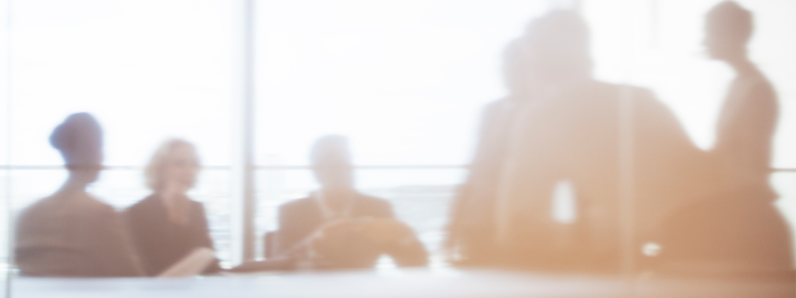 Blurred image of people in office meeting room