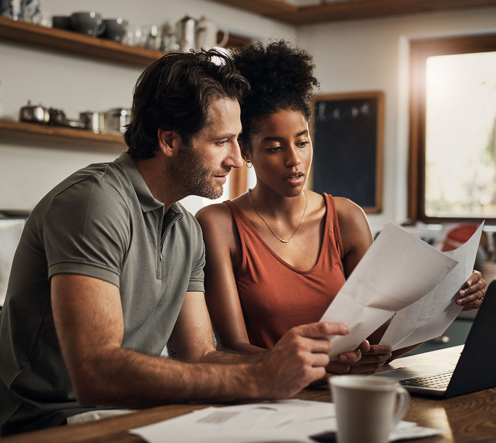 Couple going over finances in kitchen