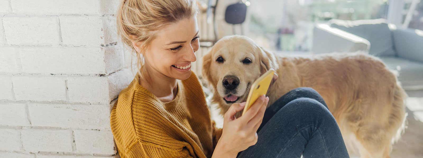 Young woman and dog in living room